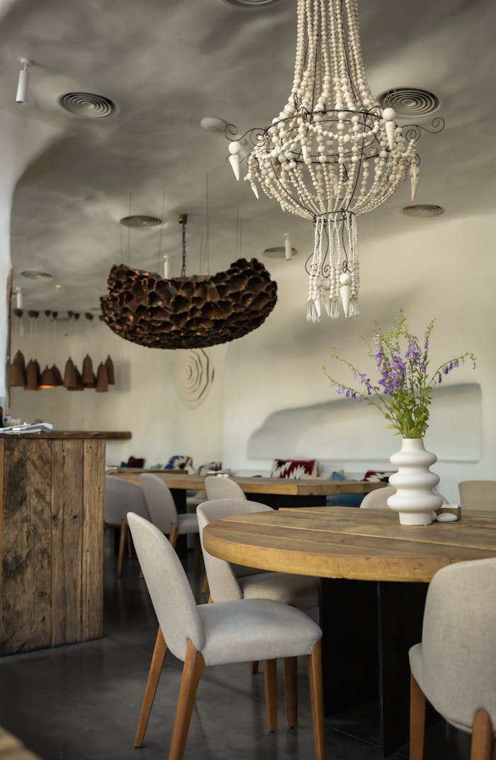 Luxurious modern dining room featuring unique chandeliers and elegant decor.