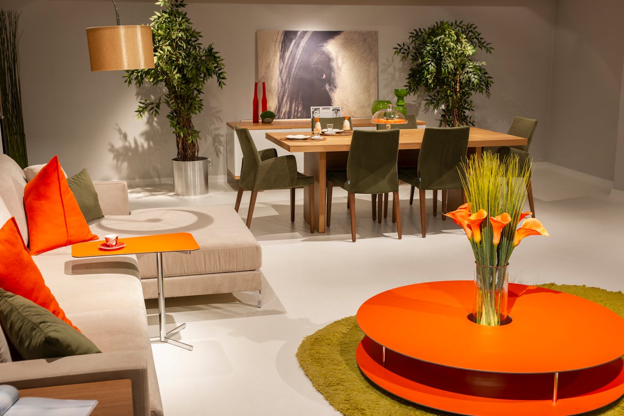 Stylish dining and living area with vibrant orange decor and elegant furnishings.